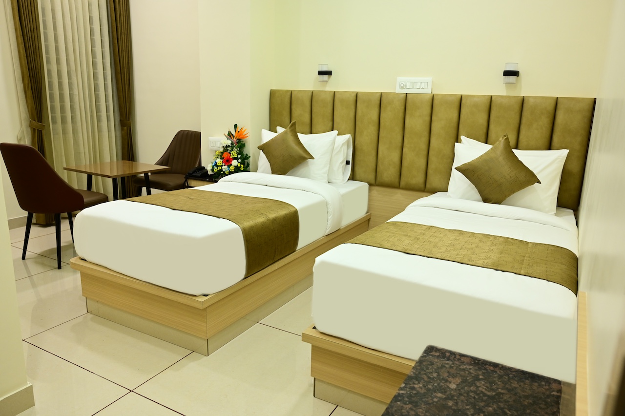 Executive twin room at SR Grand Hotel Tumkur — two single beds with premium AC and WiFi