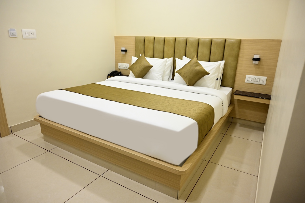 SR Grand Hotel standard room with single bed, AC, and TV — affordable stay in Tumkur